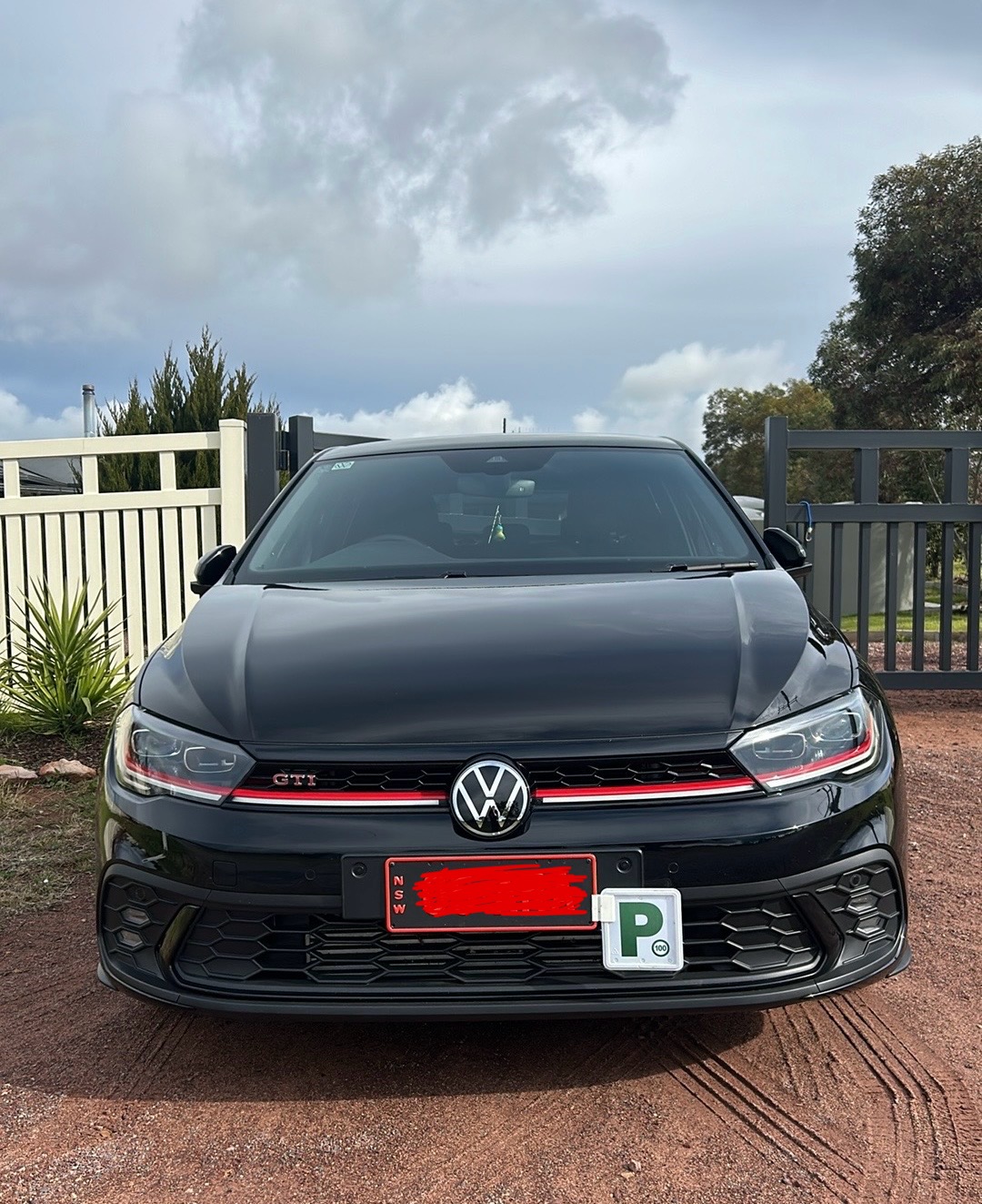 Black Volkswagen Polo GTI photographed head on after paint work, gloss even across the bonnet
